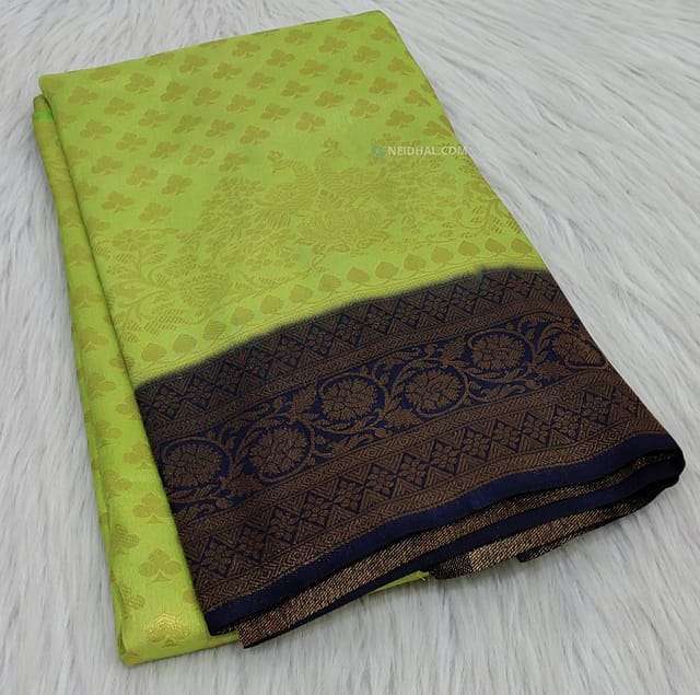 CODE WS613 :Light green soft brocade saree with antique zari woven design all over traditional peacock and floral design for the borders ,pallu with fancy tassels and running navy blue zari woven blouse