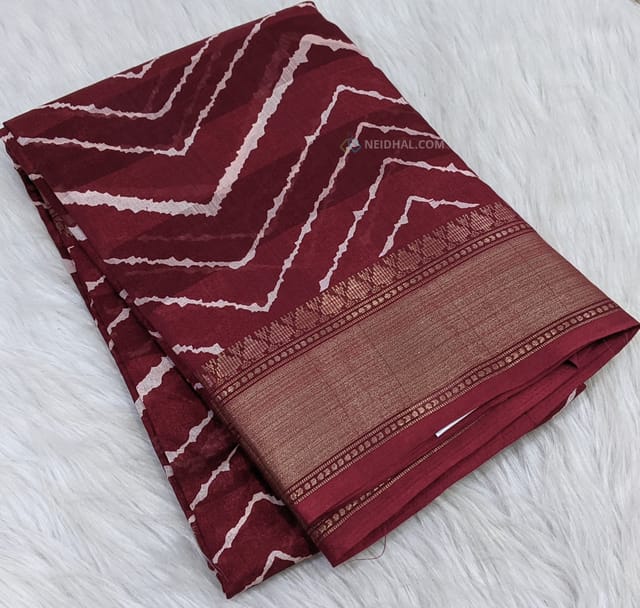 CODE WS750 : Maroon fancy dola silk saree with shibori prints all over ,simple gold tissue borders , printed pallu and running printed blouse with borders.