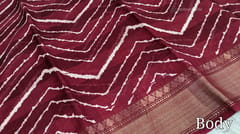 CODE WS750 : Maroon fancy dola silk saree with shibori prints all over ,simple gold tissue borders , printed pallu and running printed blouse with borders.