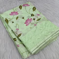 CODE WS849 : Pastel green semi crepe saree with beautiful lotus prints all over ,embroidery detailing on borders,rich embroidered pallu,running printed crepe blouse.