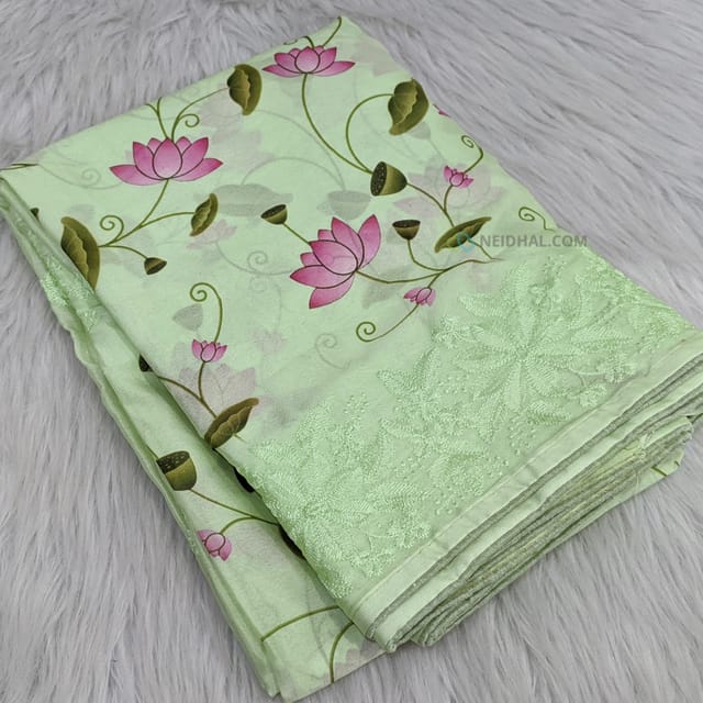 CODE WS849 : Pastel green semi crepe saree with beautiful lotus prints all over ,embroidery detailing on borders,rich embroidered pallu,running printed crepe blouse.
