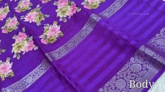 CODE WS942 : Bright purple fancy dola silk saree with beautiful floral prints all over, big gap borders on one side, ikat printed pallu,plain running blouse with borders.